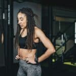 a woman with dreadlocks standing in a gym